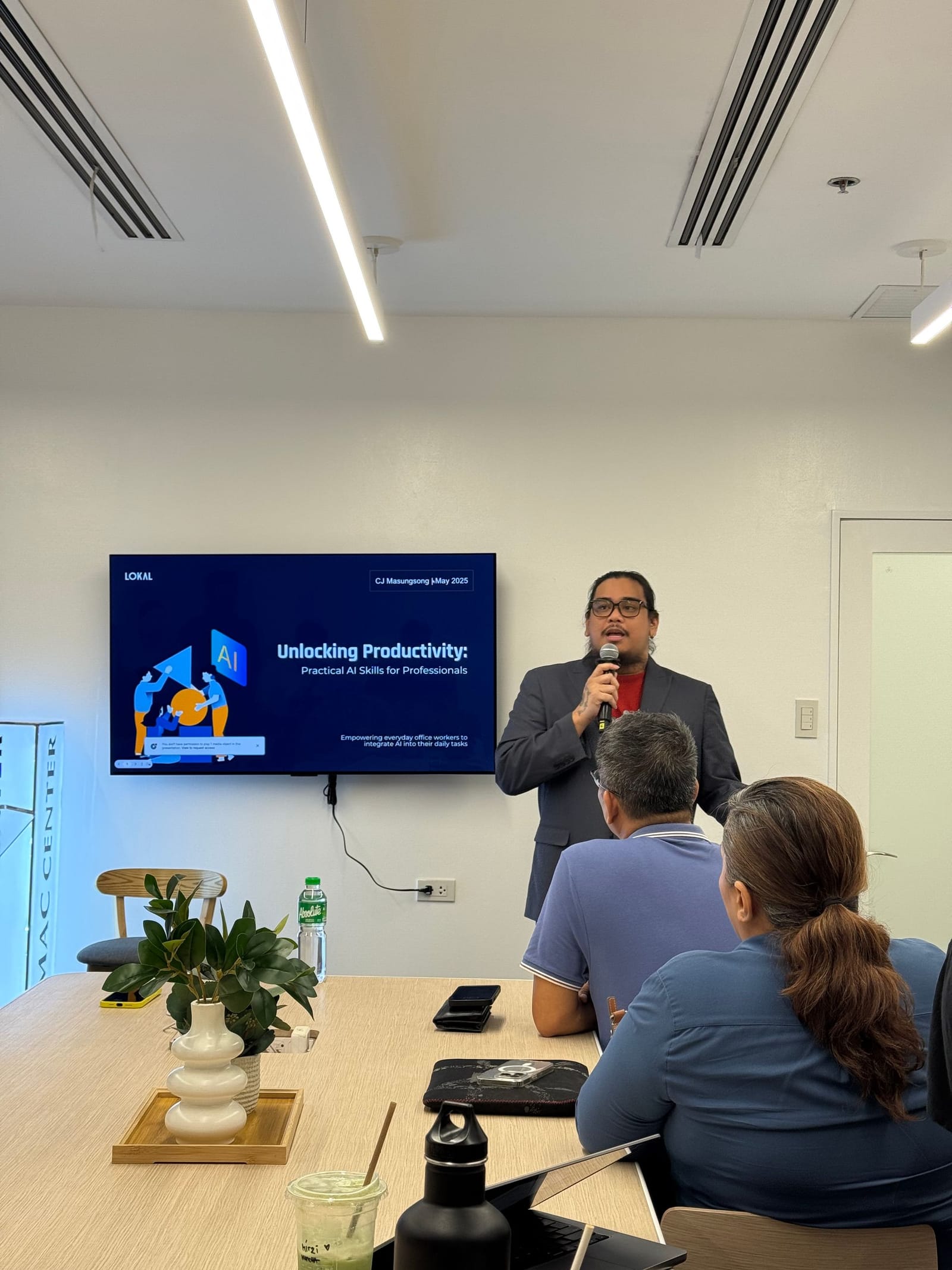 CJ Masungsong leading a LOKAL practical AI skills session for a client team in Metro Manila